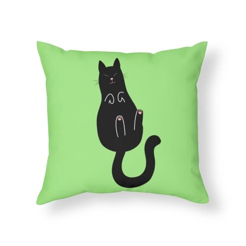 Mockup of a throw pillow featuring a simplistic drawing of a happy black cat laying on its back on a green background